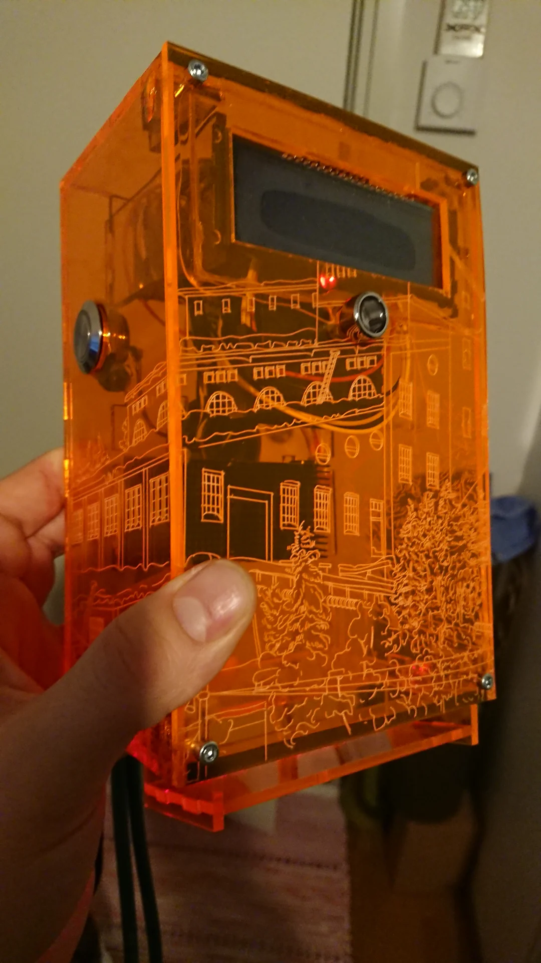 Orange acrylic enclosure with architectural engraving