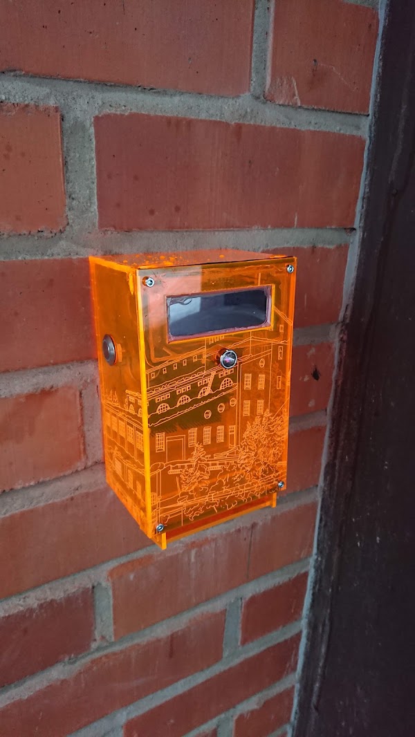 Earlier Toveri installation at Outokumpu library, with an engraved orange enclosure and no keypad yet