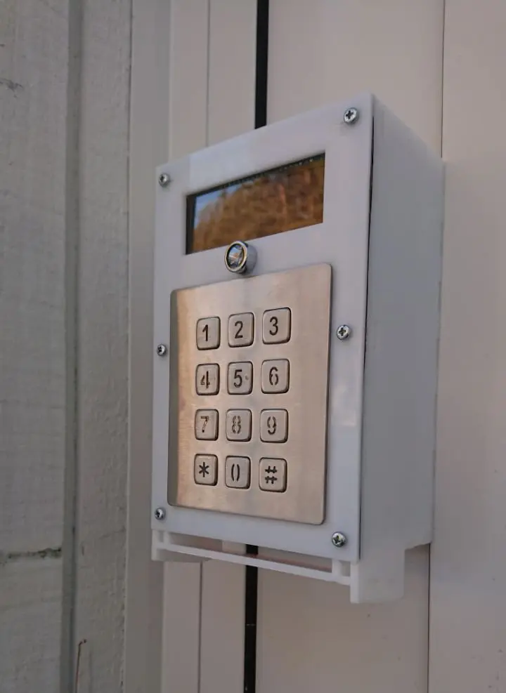 White Toveri enclosure mounted on a wall, with display and keypad
